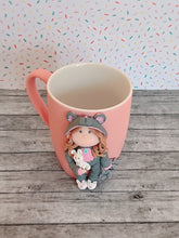 Load image into Gallery viewer, Handmade Polymer Clay 3D Girl in Grey Bear PJs on a Pink Ceramic Mug
